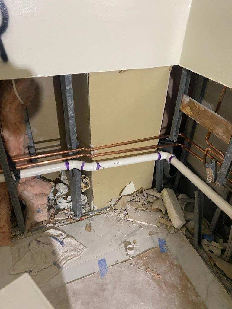 Plumbing lines exposed for professional repair
