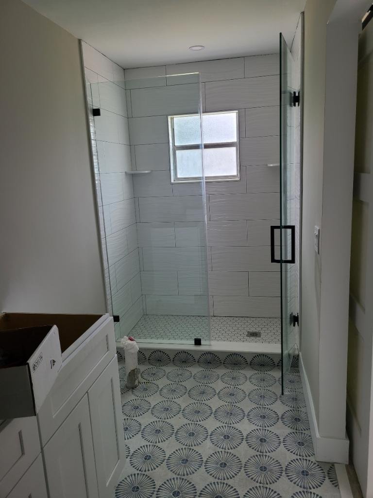 Finished shower plumbing and glass enclosure